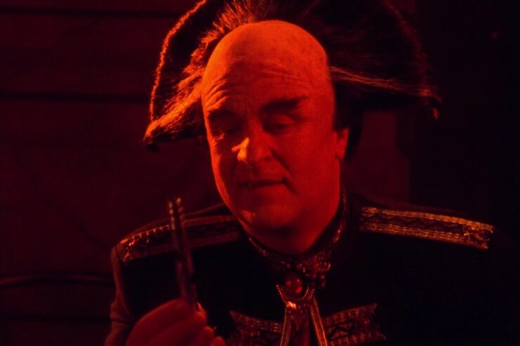 Mollari holds a poison syringe in a scene from Babylon 5 "The Long Night"