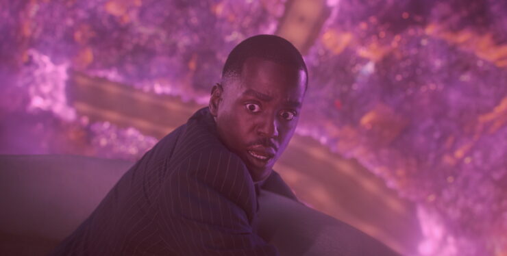 The Doctor hanging on and looking astounded in Doctor Who's "The Reality War"