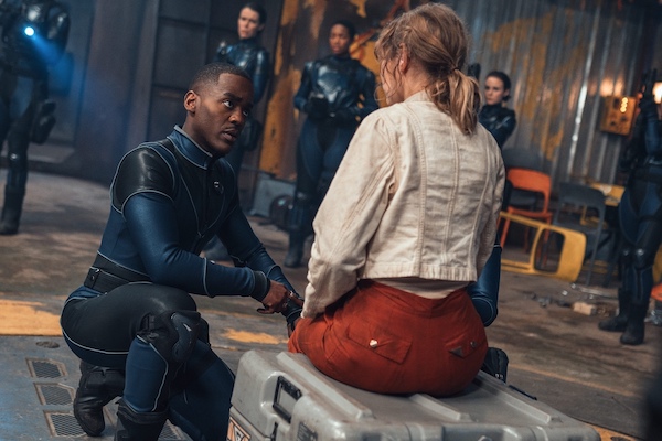 The Doctor talking to Aliss, kneeling at her feet in Doctor Who's "The Well"