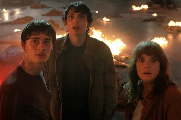 Noah Schnapp as Will Byers, Finn Wolfhard as Mike Wheeler, and Winona Ryder as Joyce Byers in Stranger Things: Season 5